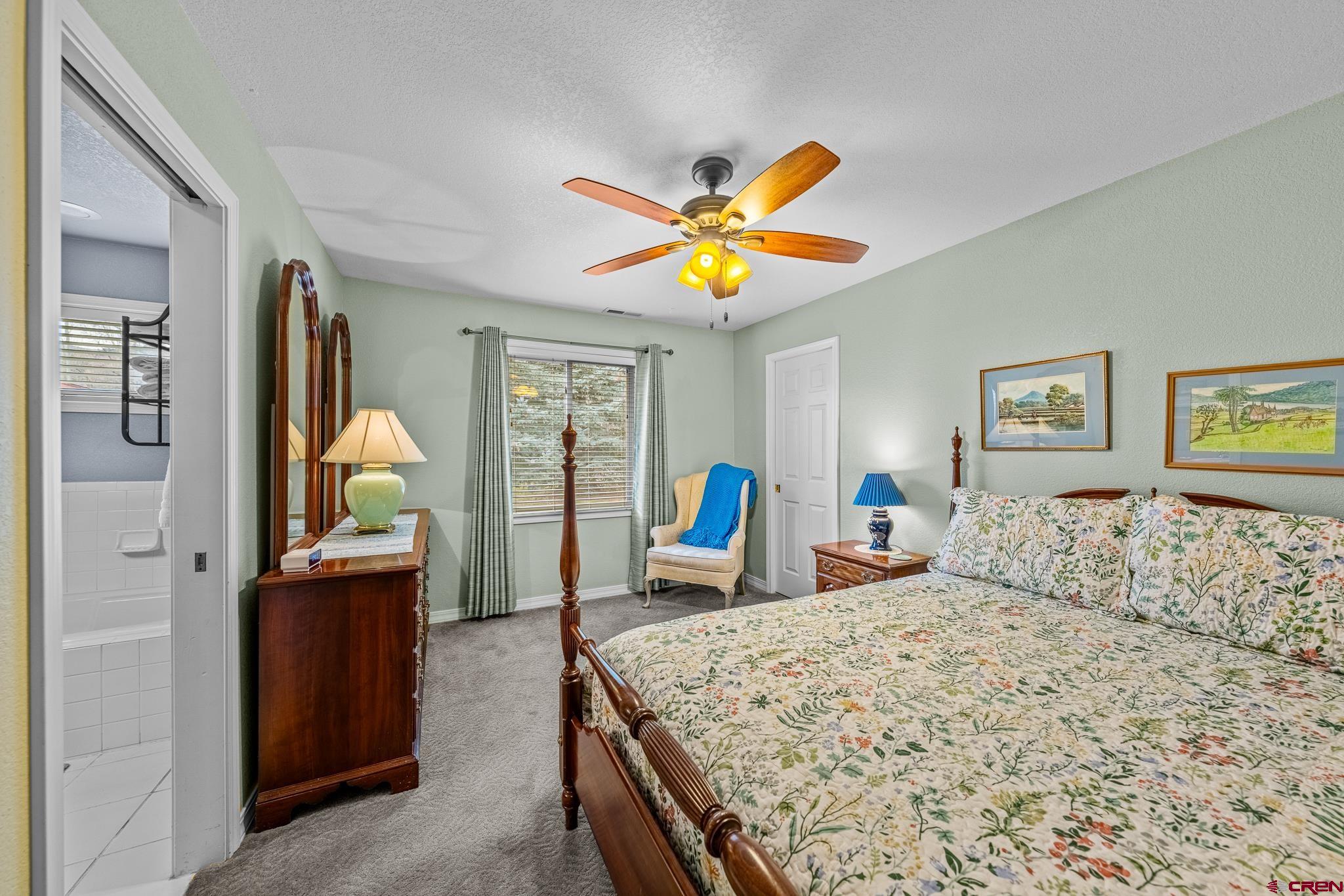 780 Waterfall Lane Durango, CO 81301 - Photo 27 of 35 a bedroom with a bed and a table