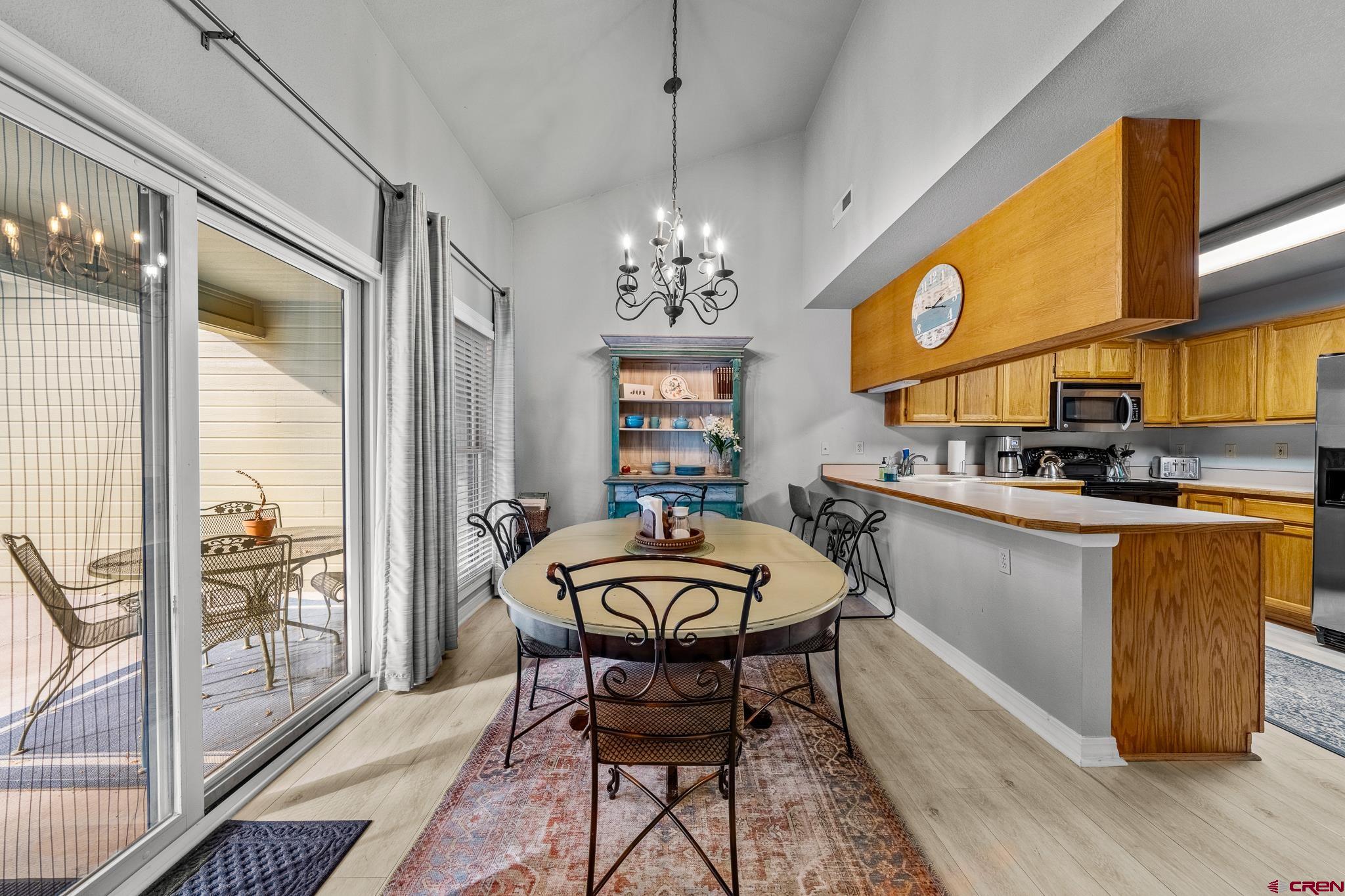 780 Waterfall Lane Durango, CO 81301 - Photo 4 of 35 a very nice looking dining room with a large window and a chandelier