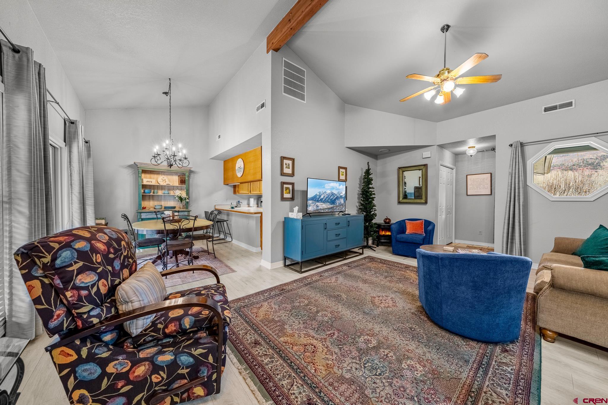 780 Waterfall Lane Durango, CO 81301 - Photo 7 of 35 a living room with furniture and a chandelier