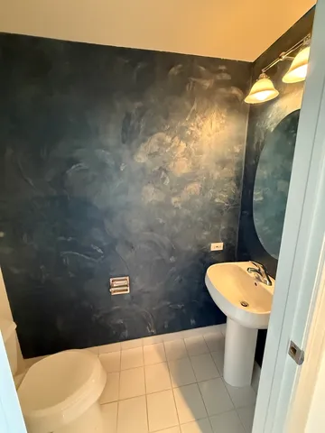 a bathroom with a toilet and a mirror