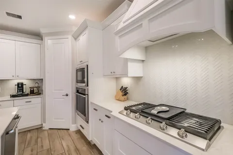 a kitchen with a sink stove and cabinets