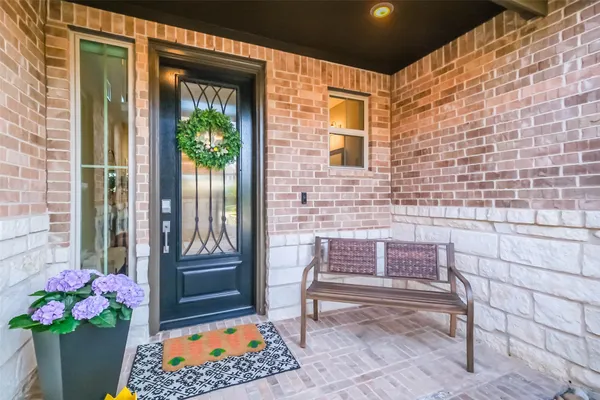 a large bed sitting in a bedroom next to a window