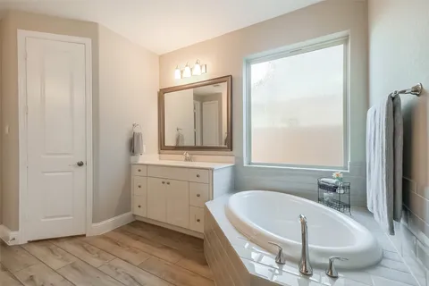 a bedroom with a bed a couch and a window