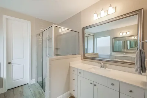 a white bath tub sitting in a bathroom and mirror