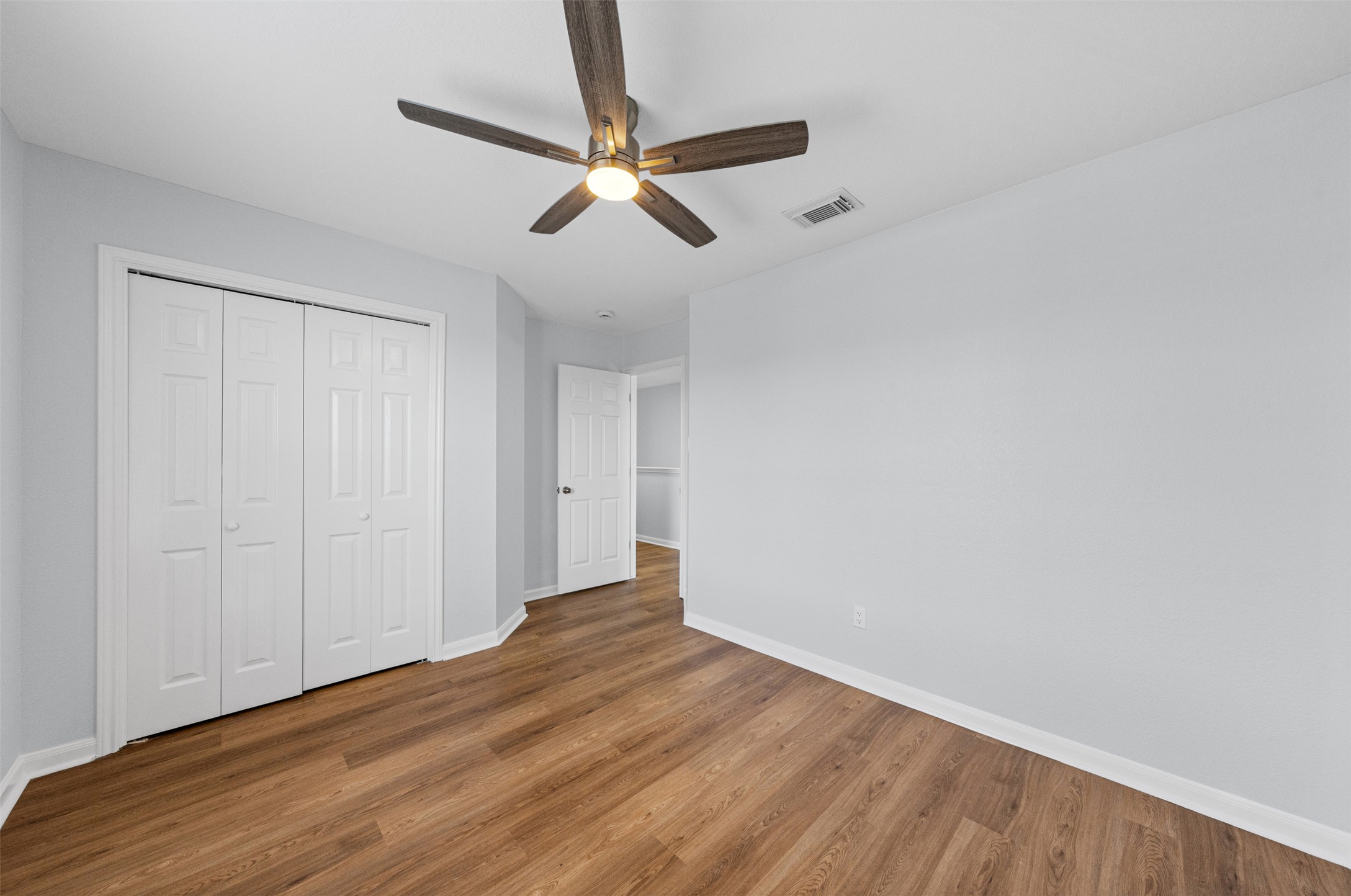 243 Engineers Pass Jarrell, TX 76537 - Photo 29 of 40 Room featuring wood-finish flooring, light gray wall paint, and white baseboards