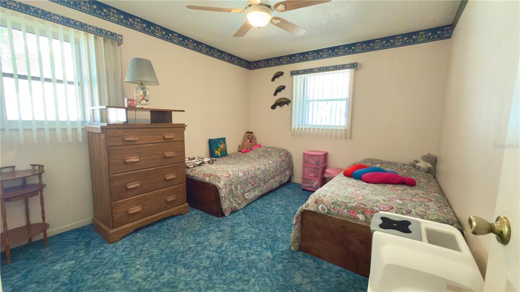 12985 116th Street Largo, FL 33778 - Photo 11 of 28 a bedroom with two beds and a dresser
