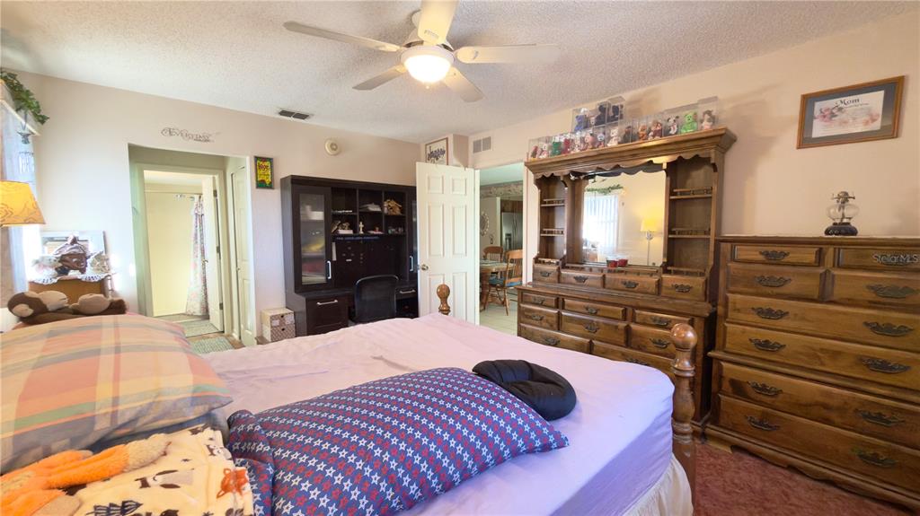 12985 116th Street Largo, FL 33778 - Photo 14 of 28 a bedroom with a bed and wooden floor