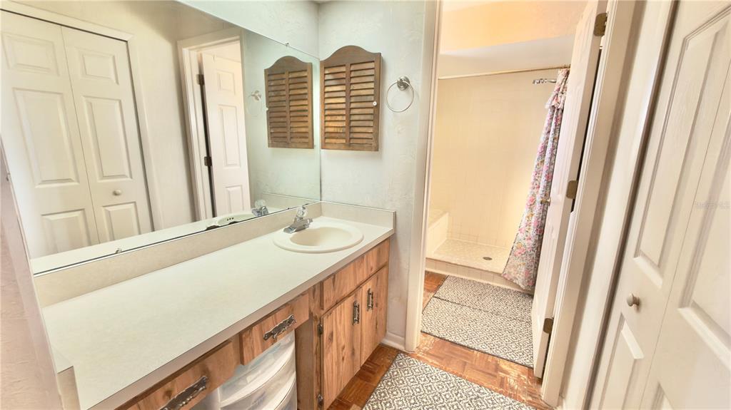 12985 116th Street Largo, FL 33778 - Photo 16 of 28 a bathroom with a sink a vanity and a mirror