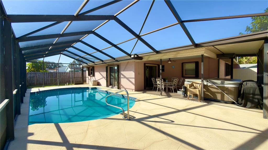 12985 116th Street Largo, FL 33778 - Photo 21 of 28 a view of a patio with table and chairs a barbeque with wooden floor
