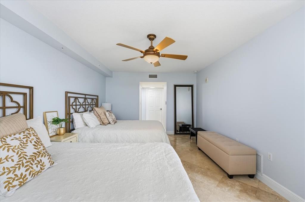 2011 North Ocean Boulevard, Unit 302 Fort Lauderdale, FL 33305 - Photo 21 of 45 a bedroom with a bed and a chandelier