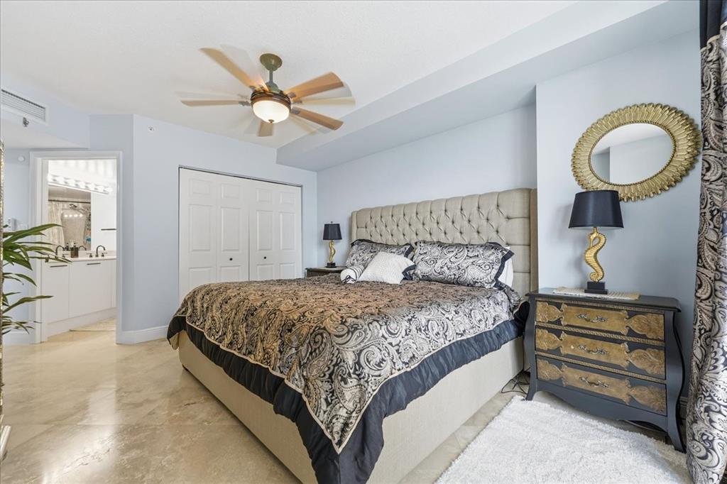 2011 North Ocean Boulevard, Unit 302 Fort Lauderdale, FL 33305 - Photo 24 of 45 a bedroom with a bed and ceiling fan
