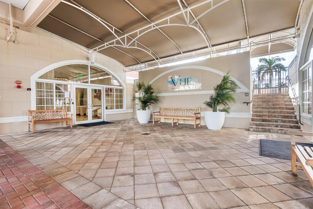 2011 North Ocean Boulevard, Unit 302 Fort Lauderdale, FL 33305 - Photo 32 of 45 a view of a porch with a bench