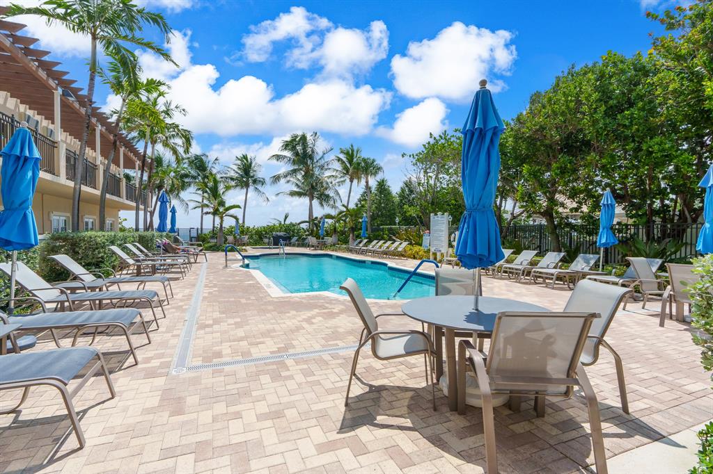 2011 North Ocean Boulevard, Unit 302 Fort Lauderdale, FL 33305 - Photo 41 of 45 a view of a swimming pool with lounge chairs in patio