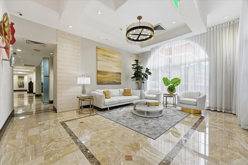 2011 North Ocean Boulevard, Unit 302 Fort Lauderdale, FL 33305 - Photo 7 of 45 a living room with furniture and a table