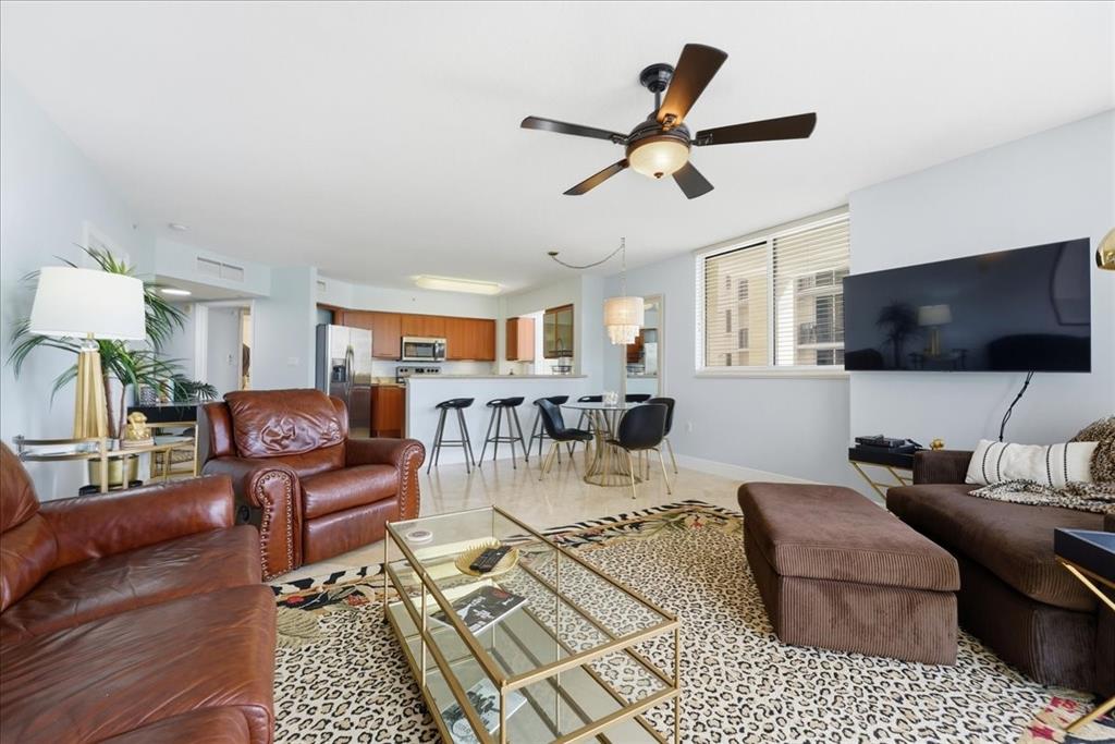 2011 North Ocean Boulevard, Unit 302 Fort Lauderdale, FL 33305 - Photo 10 of 45 a living room with furniture and a flat screen tv