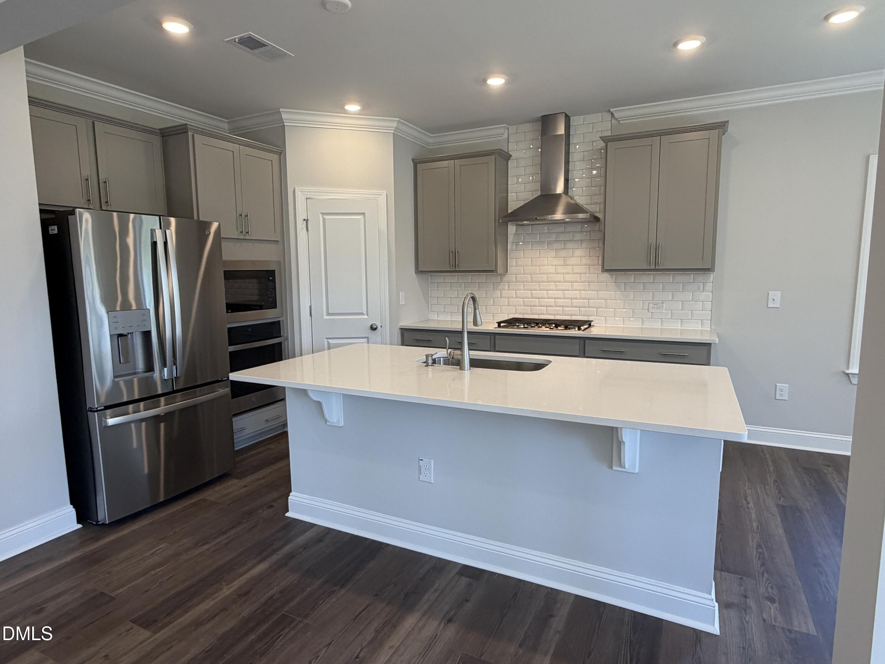 3016 Sandy Bluff Road Raleigh, NC 27616 - Photo 6 of 34 a kitchen with kitchen island a sink stainless steel appliances and cabinets