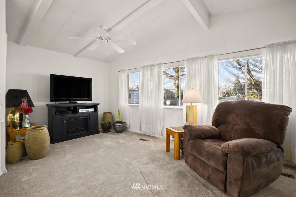201 Union Avenue Southeast, Unit 224 Renton, WA 98059 - Photo 12 of 23 a living room with furniture and a flat screen tv