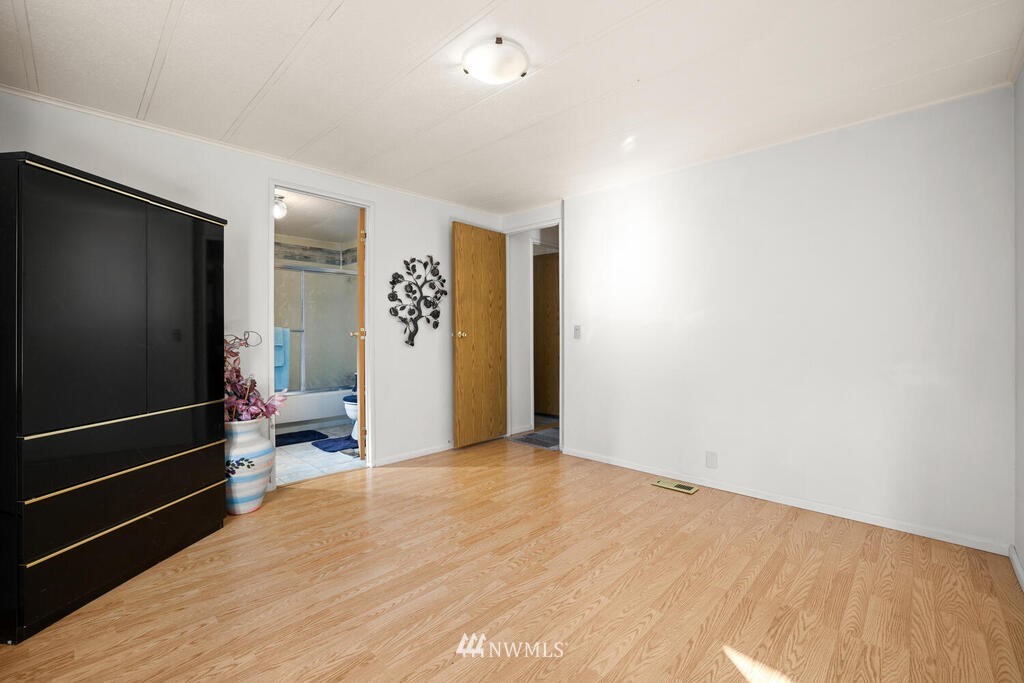 201 Union Avenue Southeast, Unit 224 Renton, WA 98059 - Photo 17 of 23 a view of a livingroom with wooden floor and a hallway