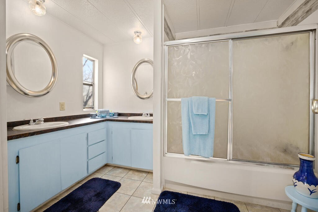 201 Union Avenue Southeast, Unit 224 Renton, WA 98059 - Photo 18 of 23 a bathroom with a double vanity sink and a mirror