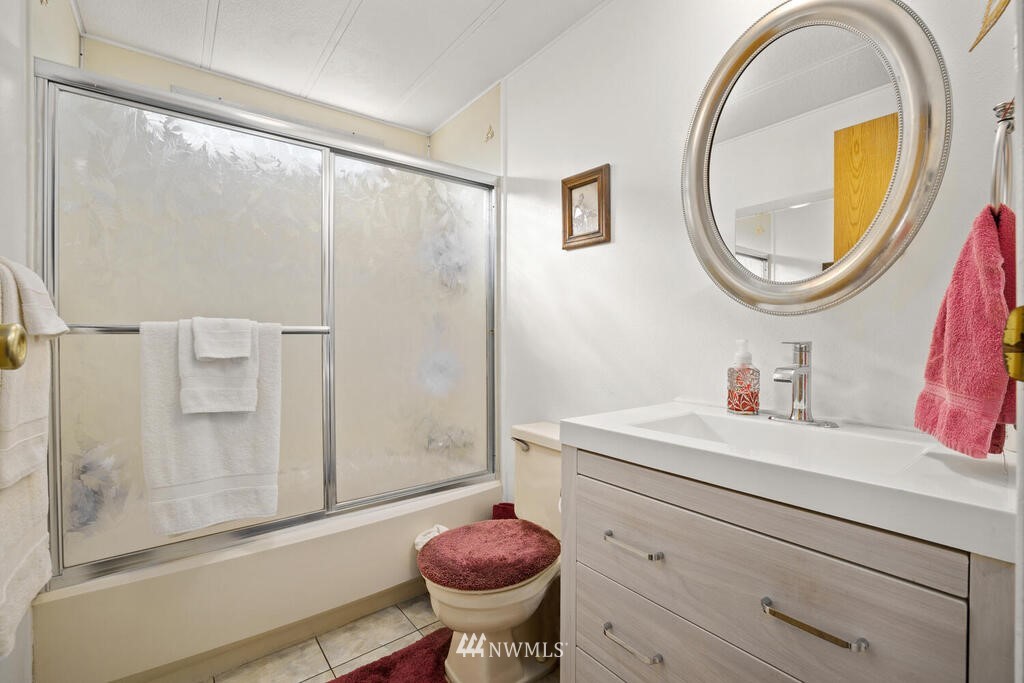 201 Union Avenue Southeast, Unit 224 Renton, WA 98059 - Photo 20 of 23 a bathroom with a sink a toilet and a mirror