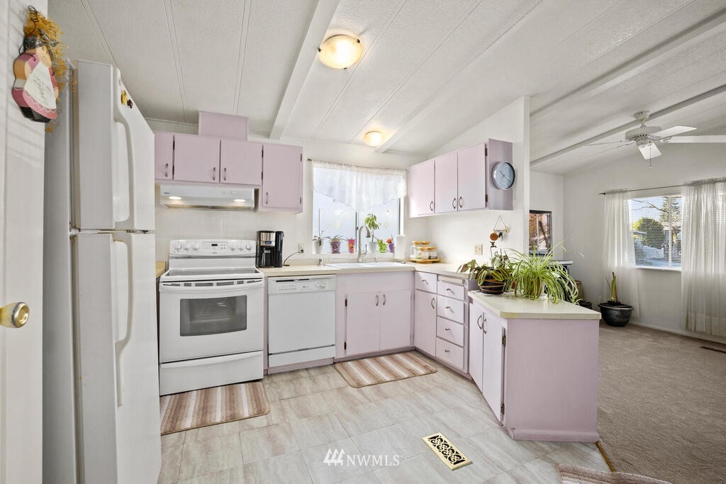 201 Union Avenue Southeast, Unit 224 Renton, WA 98059 - Photo 7 of 23 a kitchen with a white stove top oven and white cabinets