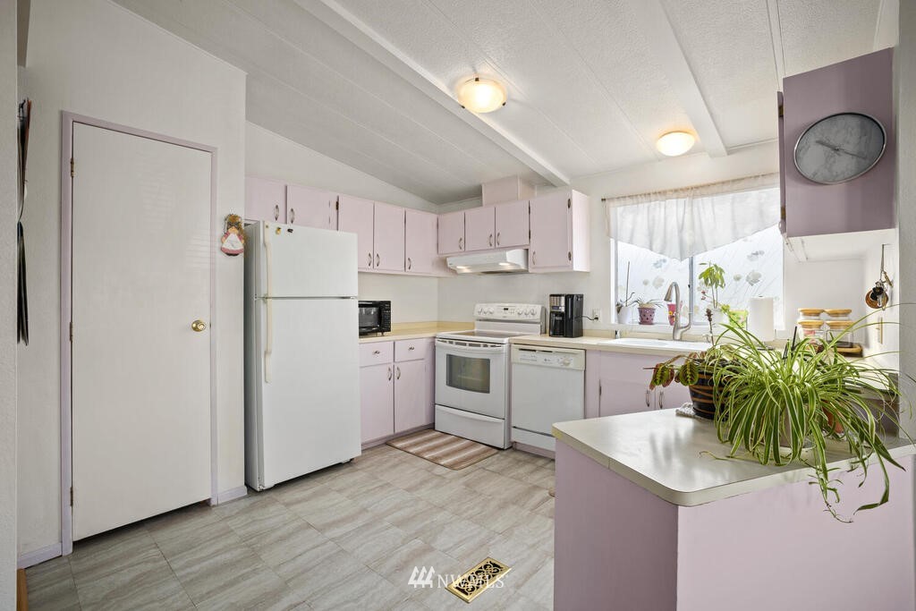 201 Union Avenue Southeast, Unit 224 Renton, WA 98059 - Photo 8 of 23 a kitchen with white cabinets and white appliances