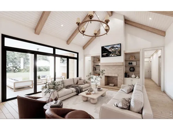 a living room with furniture a large window and a chandelier
