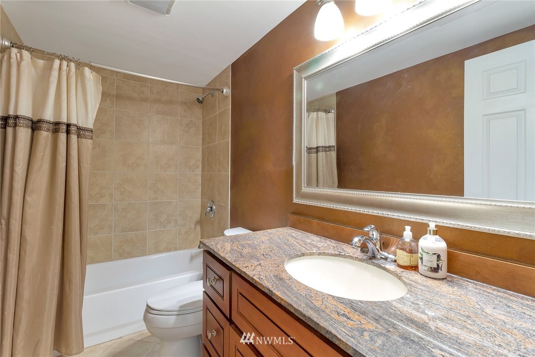 18643 Southeast 162nd Street Renton, WA 98058 - Photo 22 of 36 a bathroom with a granite countertop sink toilet and shower