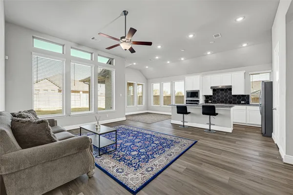 a living room with furniture and wooden floor