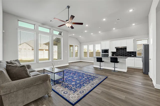 a living room with furniture and wooden floor