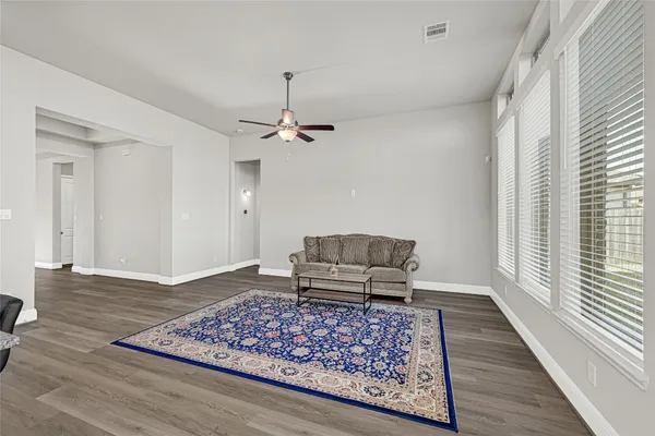 an empty room with wooden floor and window