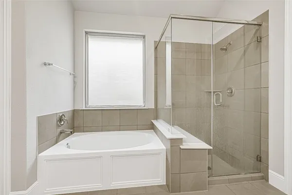 a bathroom with a shower and a bath tub