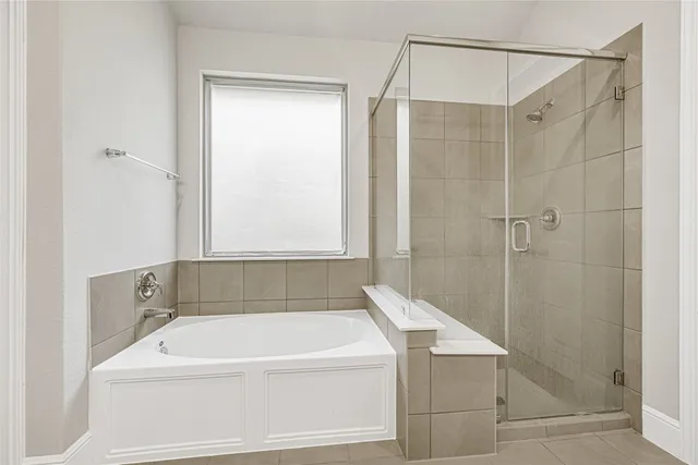 a bathroom with a shower and a bath tub