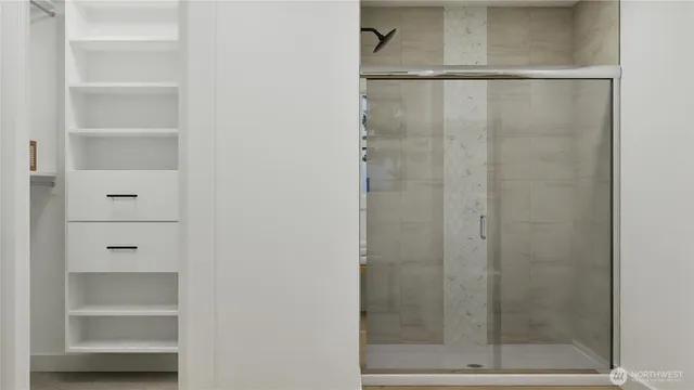 a bathroom with a glass shower door