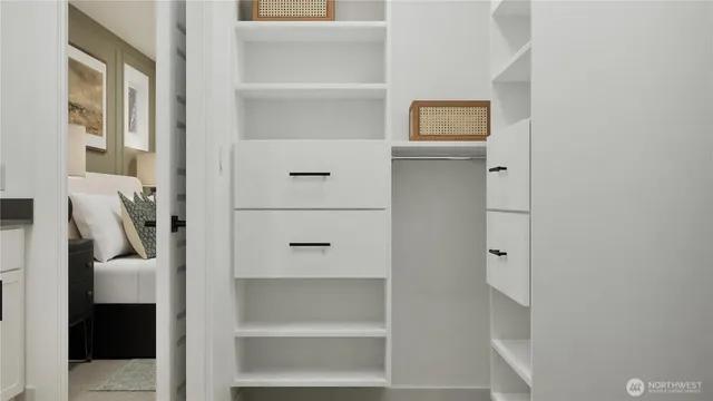 a view of walk in closet with empty racks
