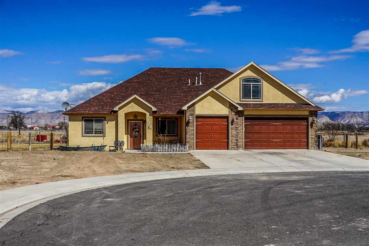 1860 Golden Ranch Road Fruita, CO 81521 - Photo 1 of 27 a front view of a house with a yard and garage