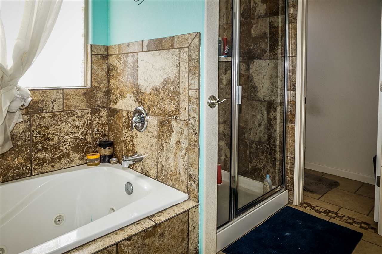 1860 Golden Ranch Road Fruita, CO 81521 - Photo 13 of 27 a bathroom with a tub and shower