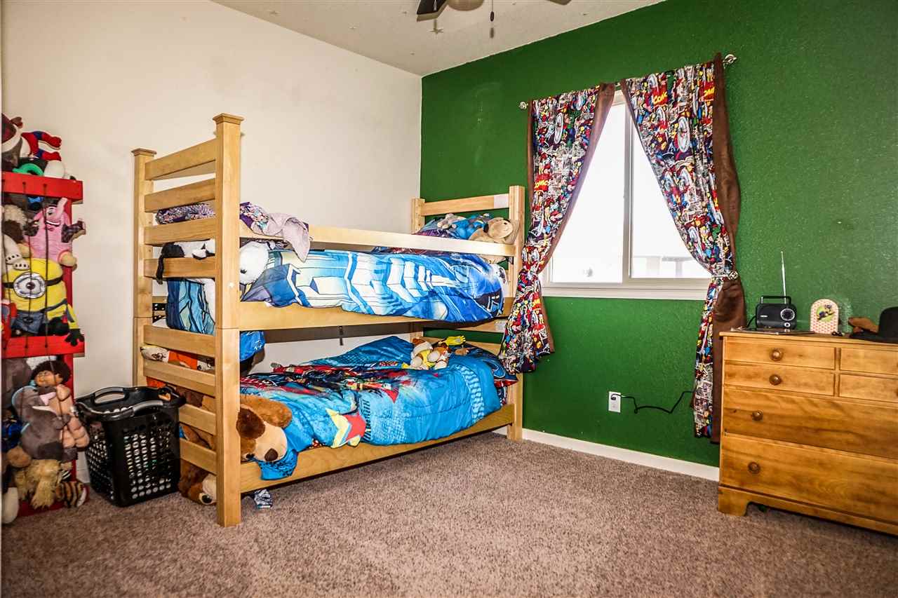 1860 Golden Ranch Road Fruita, CO 81521 - Photo 14 of 27 a bedroom with a bed and a window