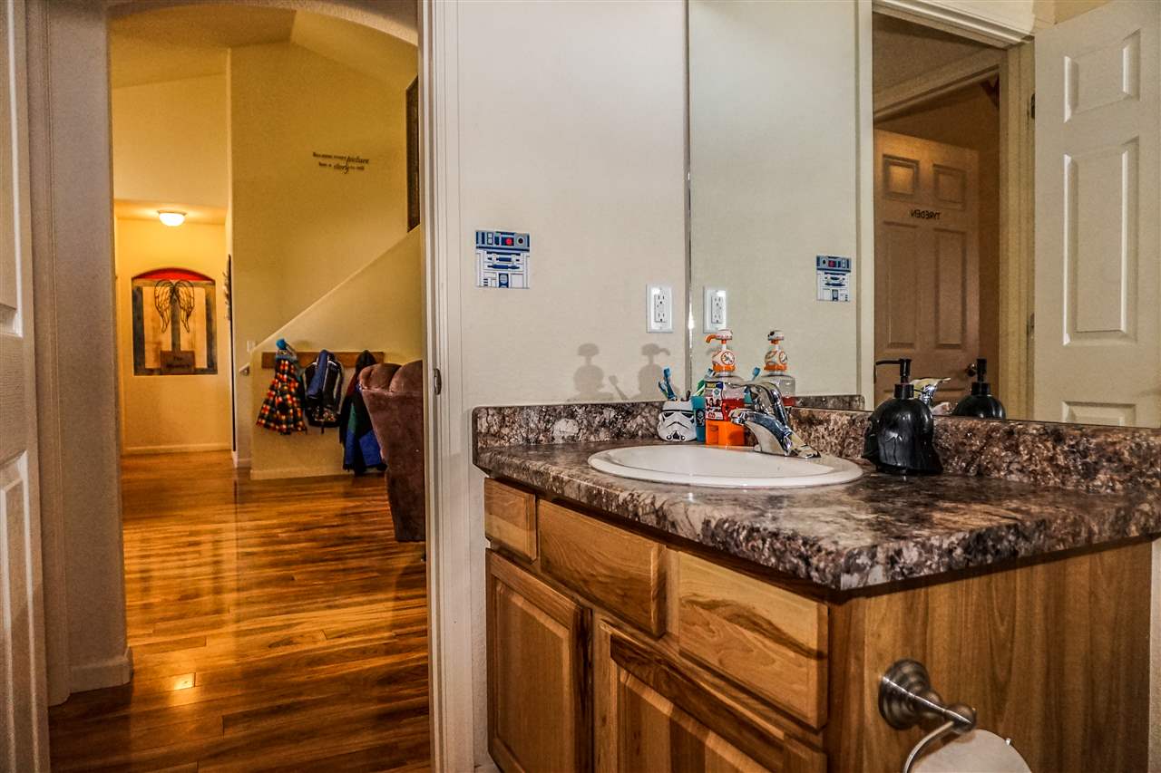 1860 Golden Ranch Road Fruita, CO 81521 - Photo 18 of 27 a bathroom with a granite countertop sink and a mirror