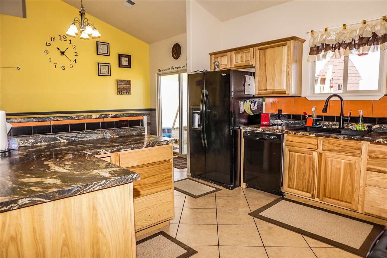 1860 Golden Ranch Road Fruita, CO 81521 - Photo 6 of 27 a kitchen with stainless steel appliances granite countertop a stove refrigerator and cabinets