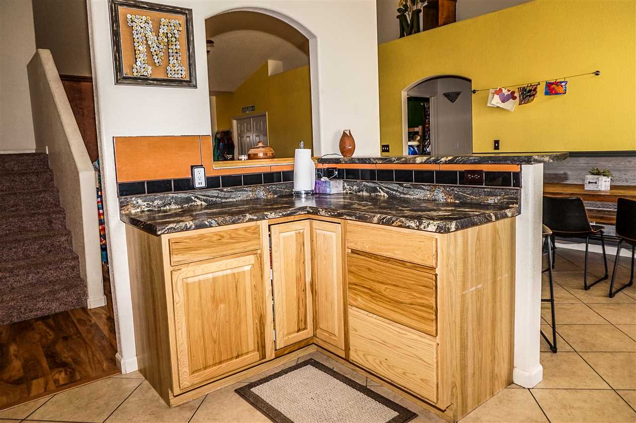 1860 Golden Ranch Road Fruita, CO 81521 - Photo 9 of 27 a kitchen with stainless steel appliances granite countertop a stove a sink and a refrigerator