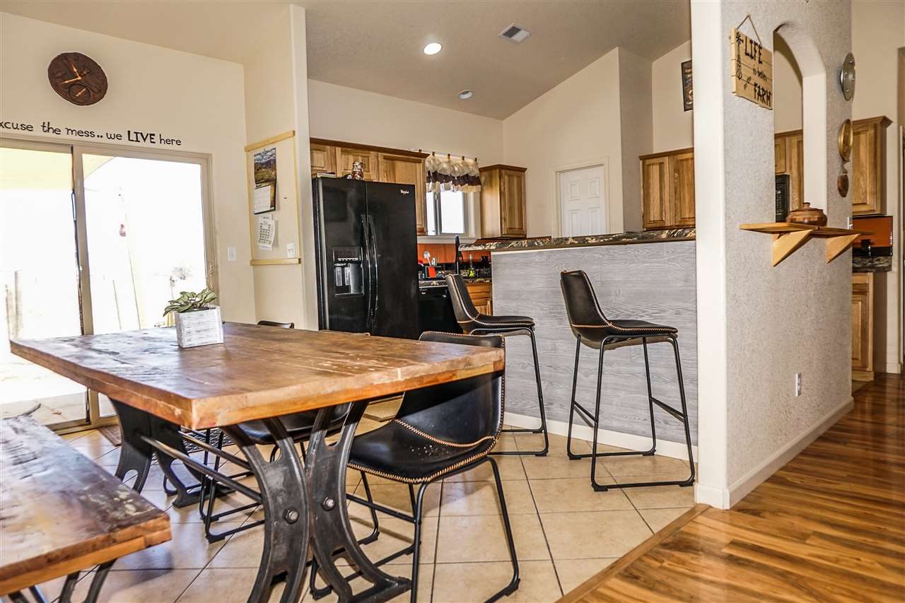 1860 Golden Ranch Road Fruita, CO 81521 - Photo 10 of 27 a dining room with stainless steel appliances kitchen island granite countertop a dining table chairs and granite counter tops