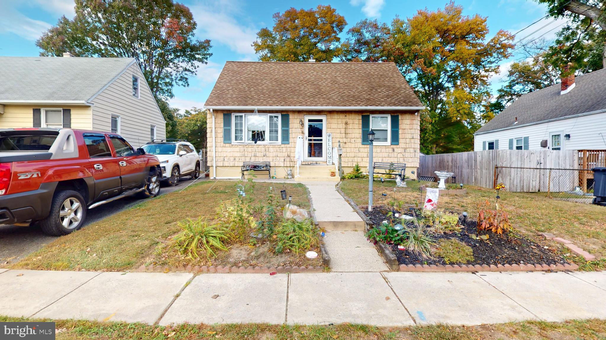 a front view of a house with a garden and outdoor seating