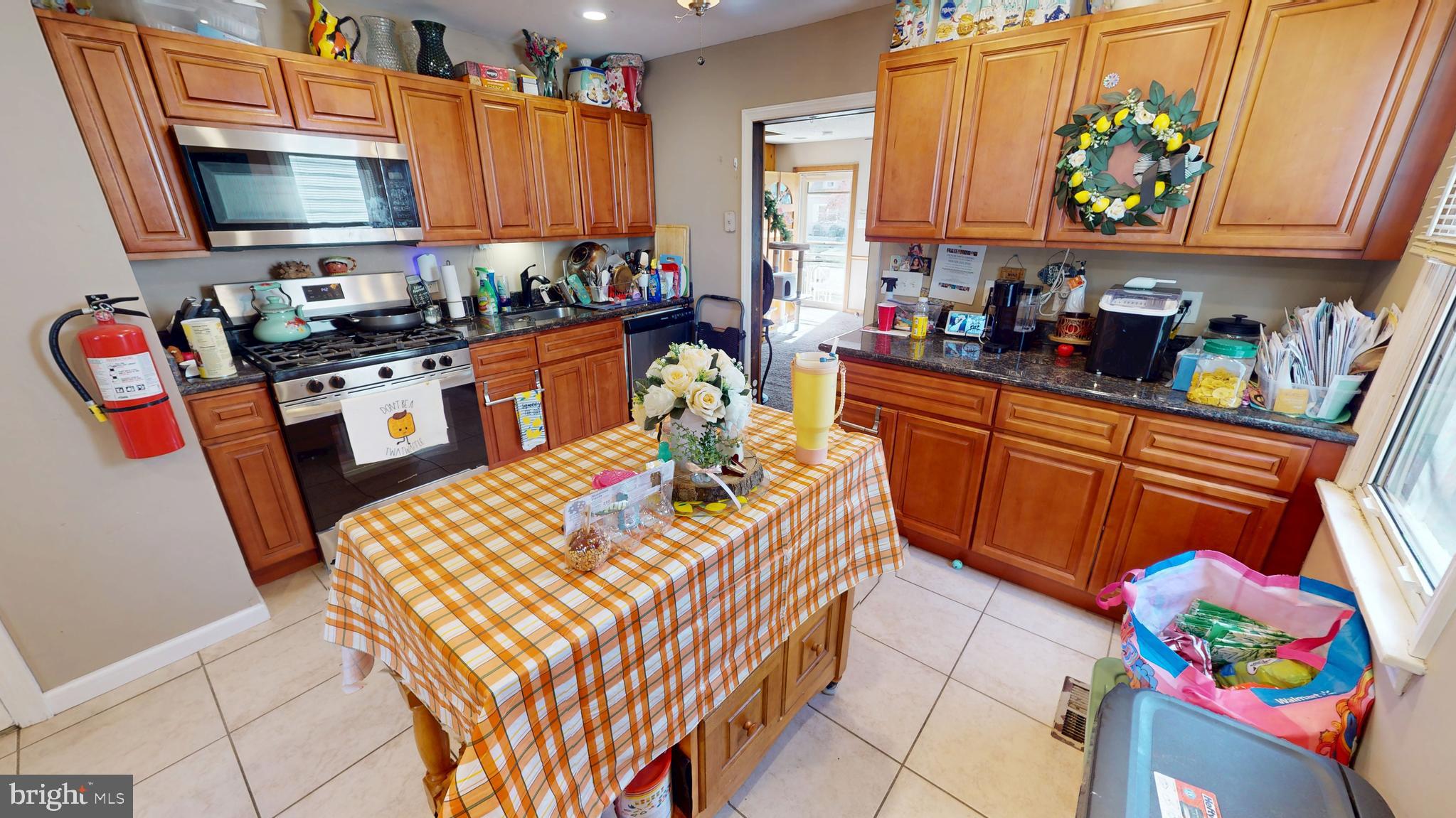 13 Cordelia Avenue Westville, NJ 08093 - Photo 7 of 25 a kitchen with stainless steel appliances a sink a stove a microwave a sink and cabinets