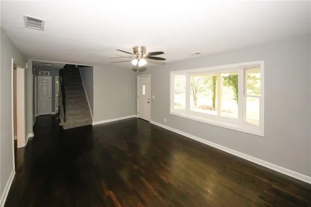 a kitchen with stainless steel appliances granite countertop a sink and a white cabinets