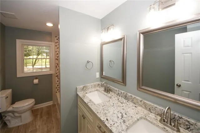 a bathroom with a sink vanity and a mirror