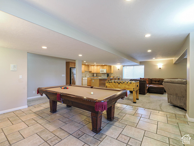 11779 South Stone Ridge Court Ridge West Riverton, UT 84065 - Photo 52 of 85 Spacious entertainment area featuring a tiled floor, recessed lighting, and a partial kitchen with wood cabinetry