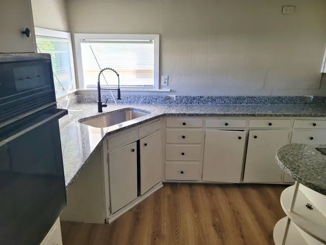 a kitchen with a sink and cabinets