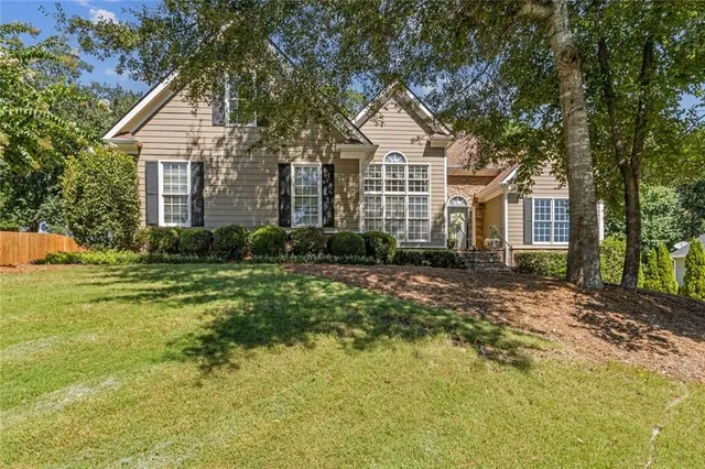 a front view of a house with a yard