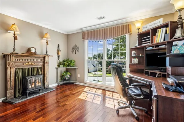 a living room with furniture ceiling fan and a rug